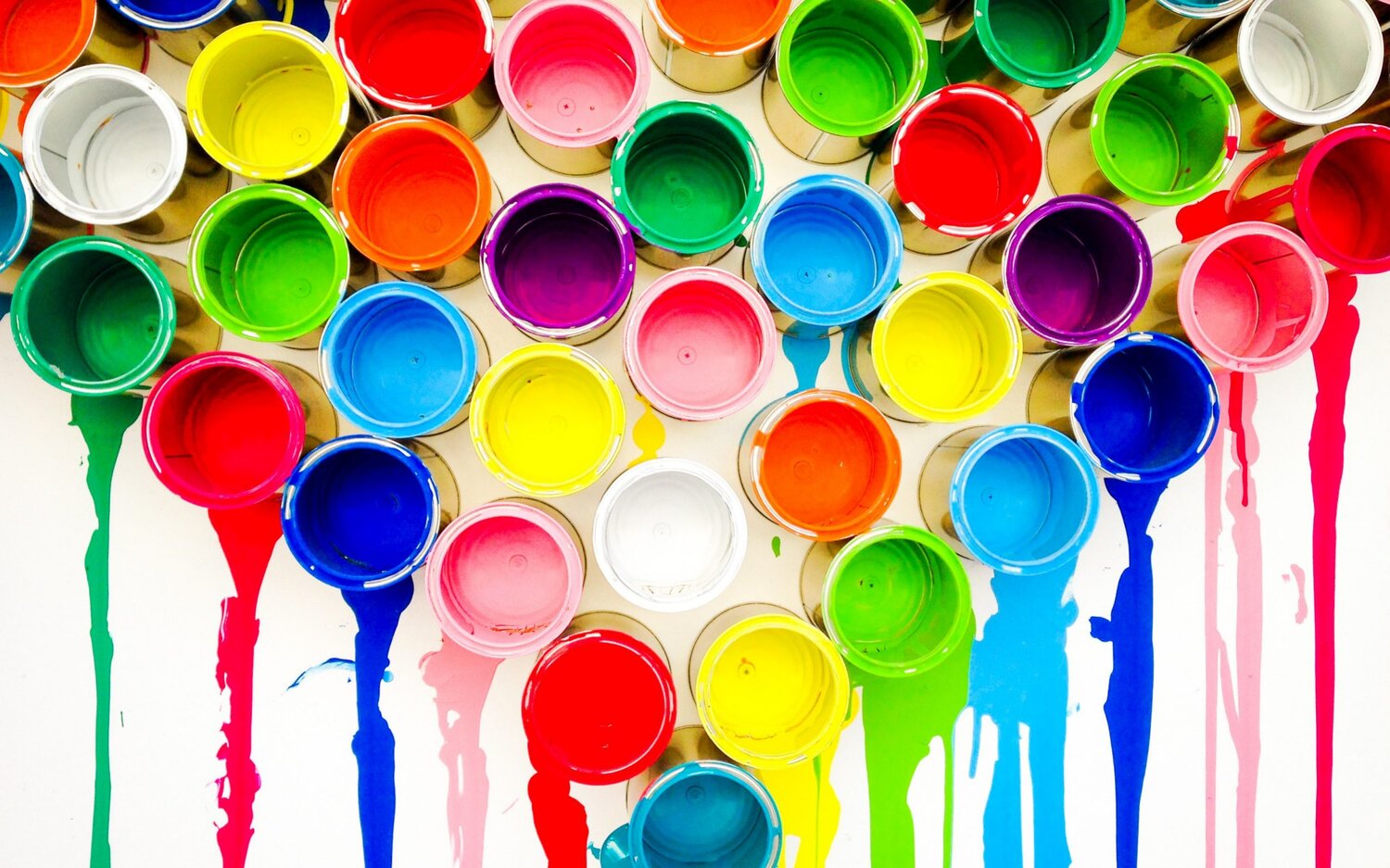 Multiple paint cans of different colors dripping paint
