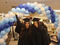 Students at the grad fair in cap and gown 