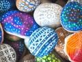 Stones painted with vibrant colors and patterns