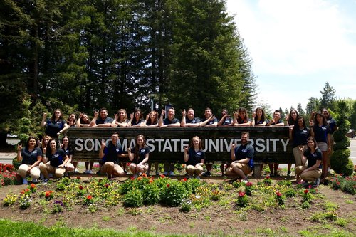 Students behind Sonoma State University sign 