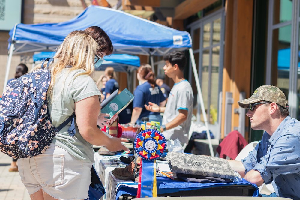 Students interacting at an outdoor tabling event