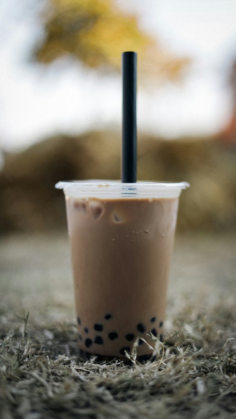 A boba drink in a plastic to-go cup