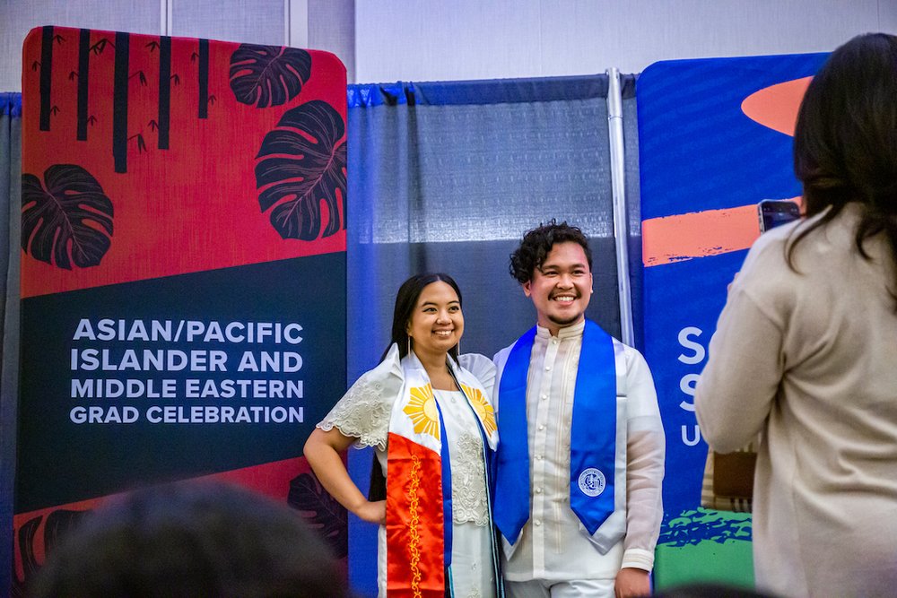 Students smiling and posing for a picture at AAPI Graduation