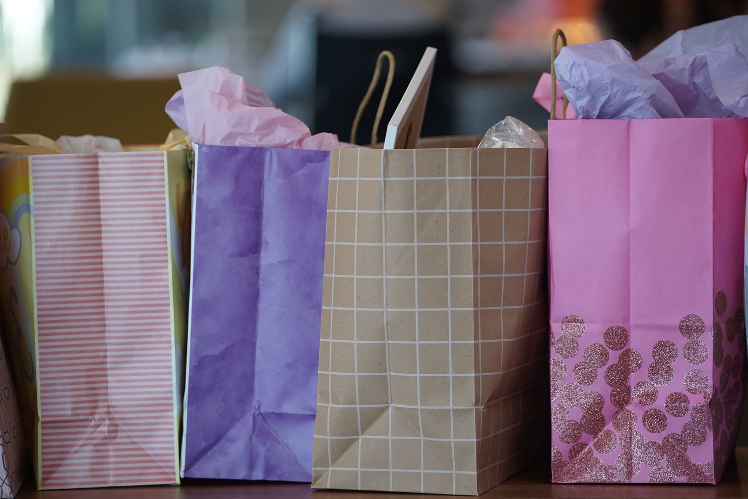 A row of colorful and patterned gift bags 