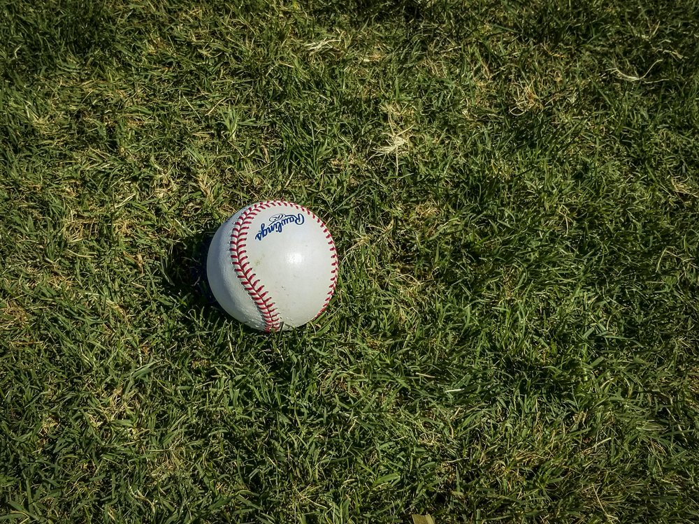 A baseball in grass