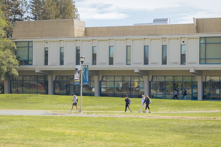 Students walking through the campus quad on a sunny day