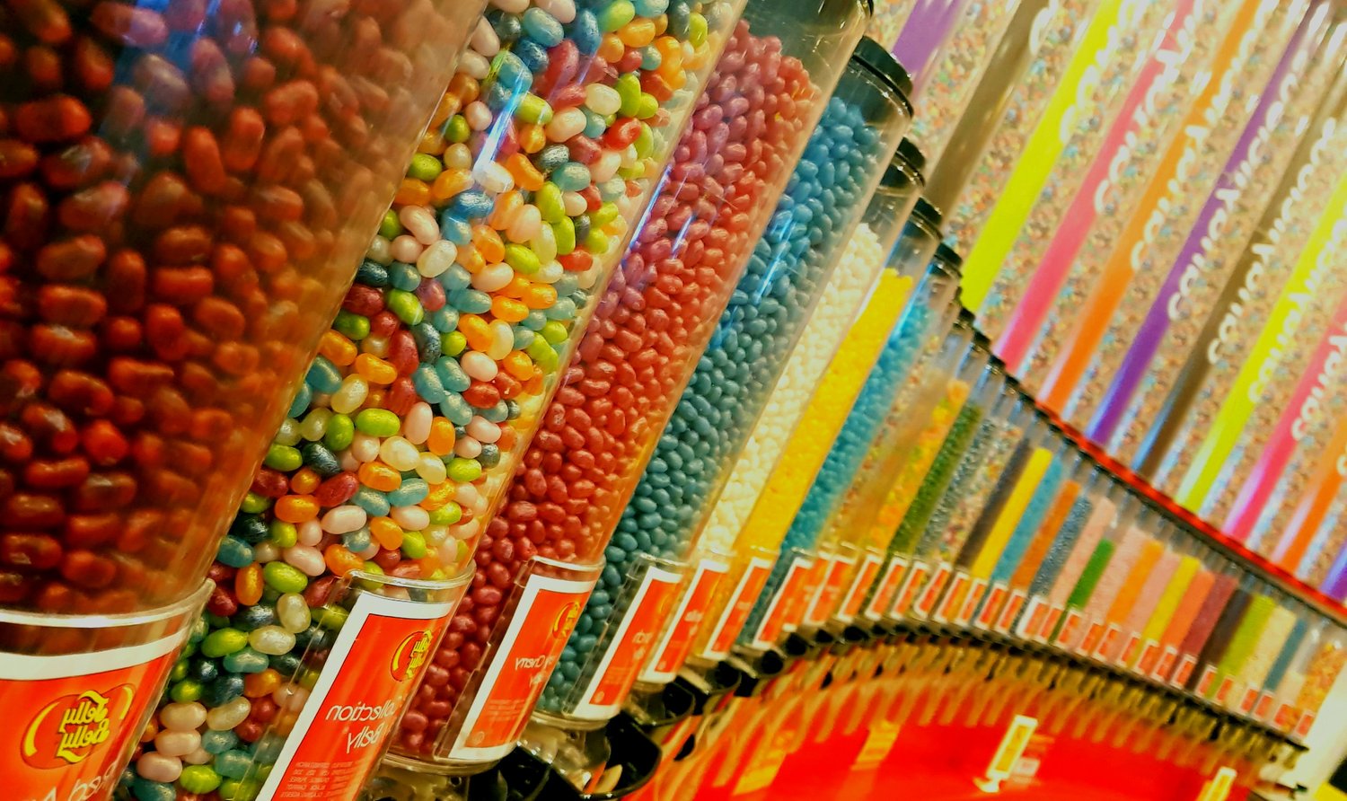 A row of colorful candy dispensers 