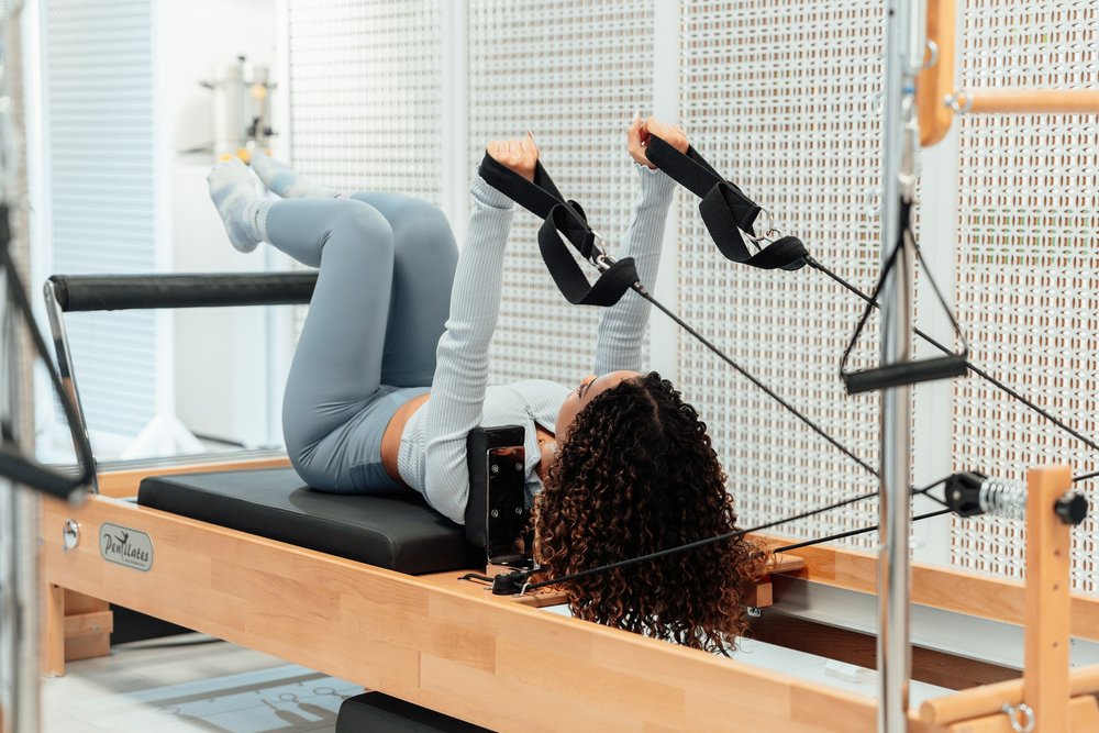 Someone exercising on a pilates machine