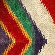 Knitted fabric with white, red, purple, green, and gold details 