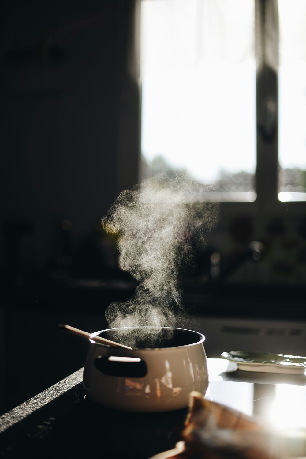 A steaming pot on top of an electric stove