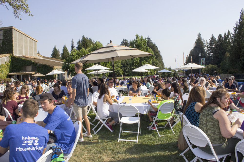 People seated at a celebration happening on Person Lawn