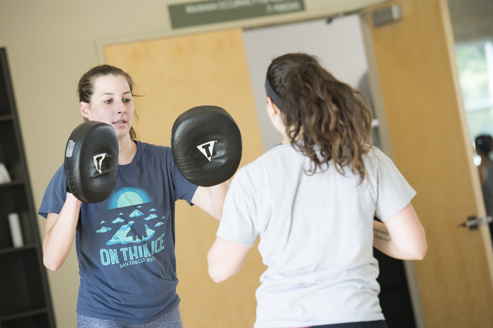 Two people kickboxing in the SSU gym