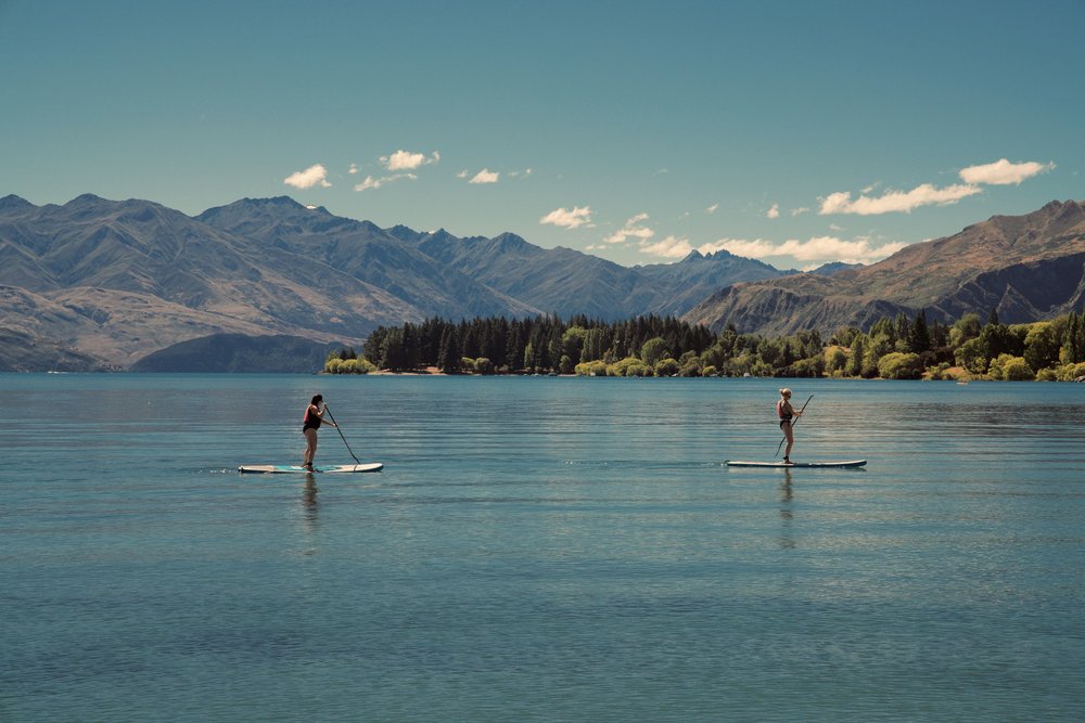 Two people paddleboarding on a lake