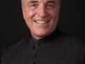 Portrait of Andy Collinsworth smiling while wearing a black button-up shirt