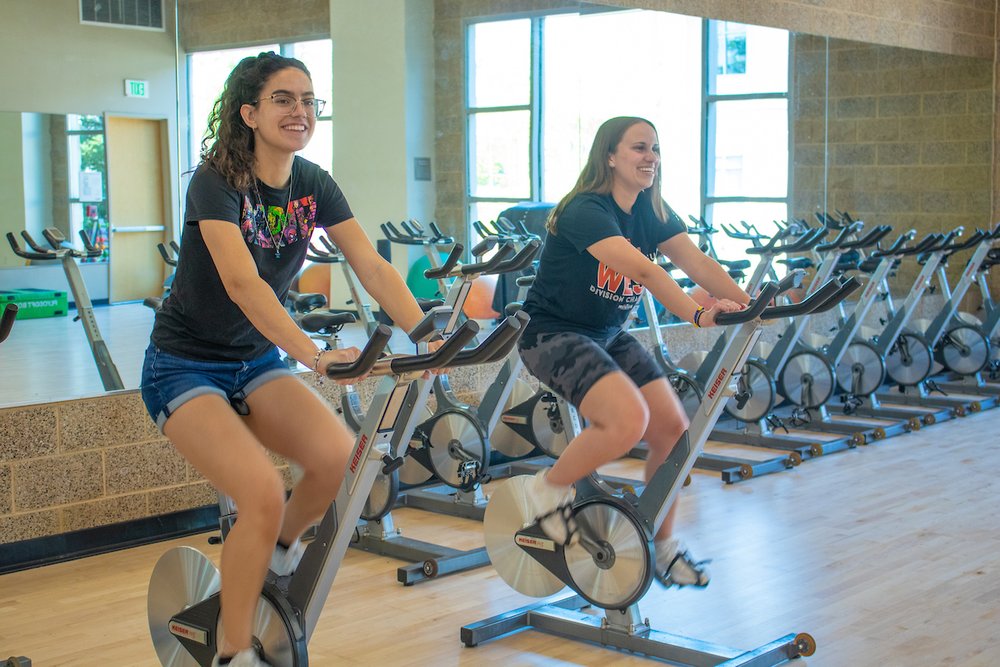 Students using the cycles in the Campus Recreation building