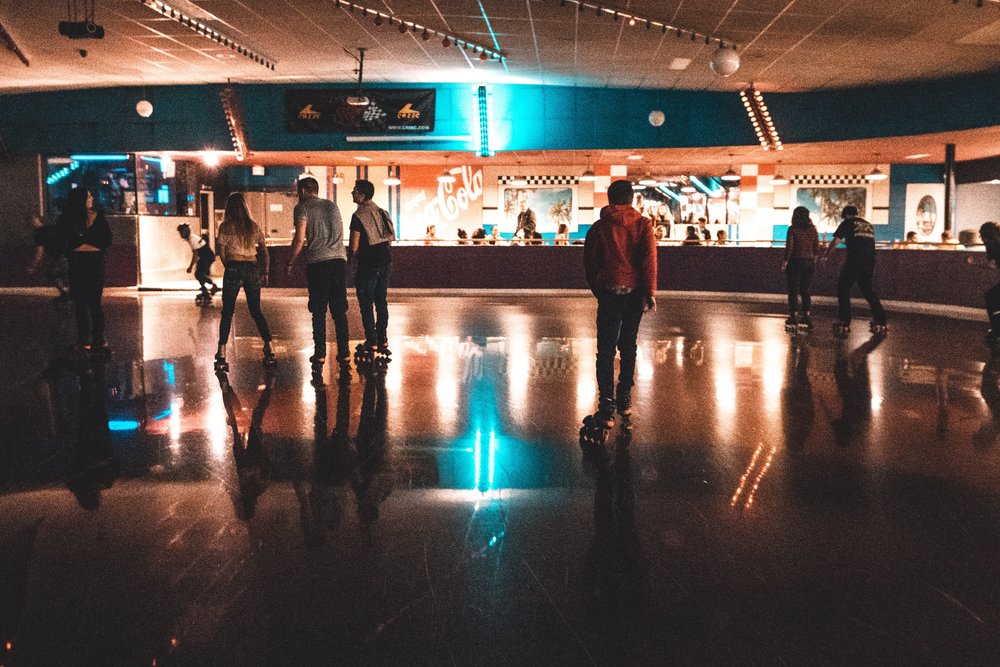 people rollerskating in an indoor roller rink