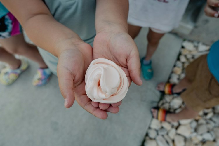 Someone holding a handful of pink slime