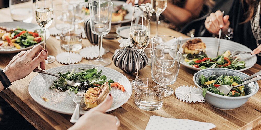 People eating food at a decorated table 