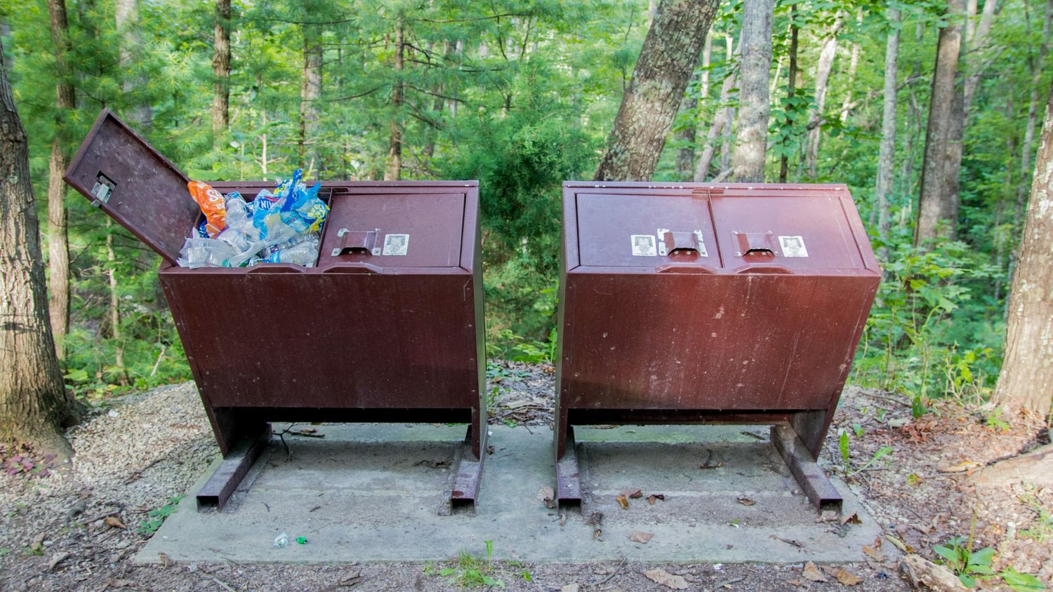 Two brown outdoor trash receptacles