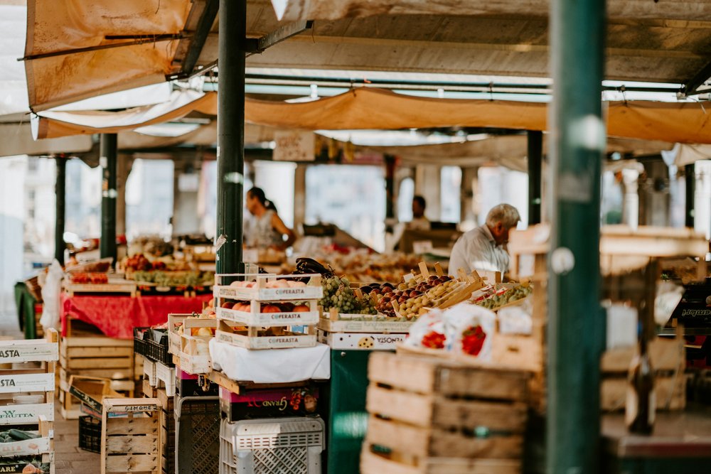 Stalls full of produce at a Farmer's Market