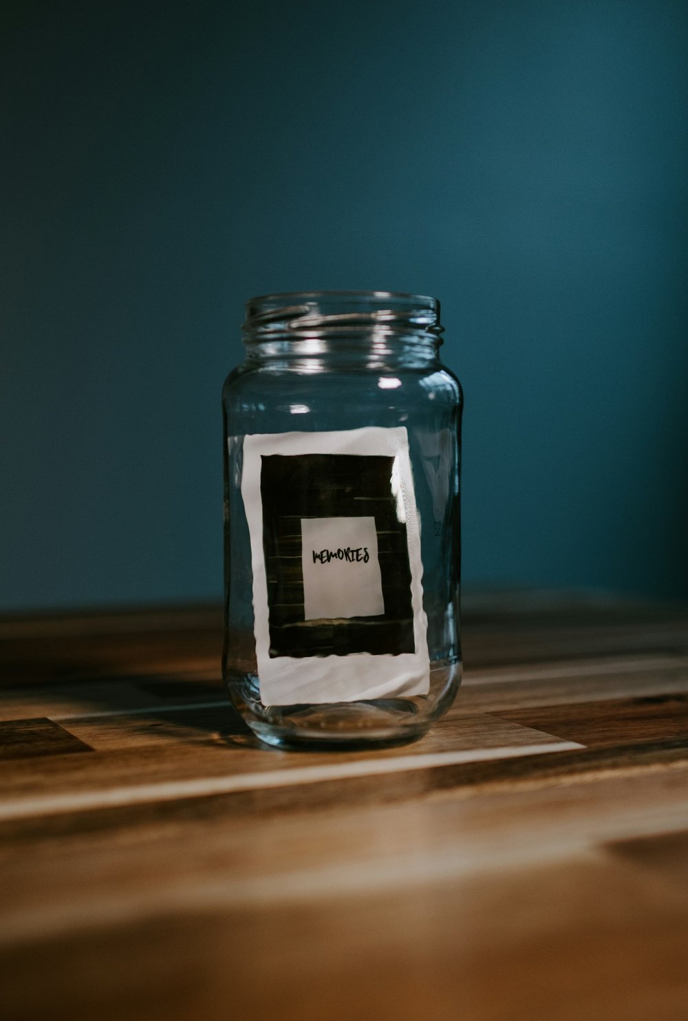 A glass jar with the word "Memories" written on it