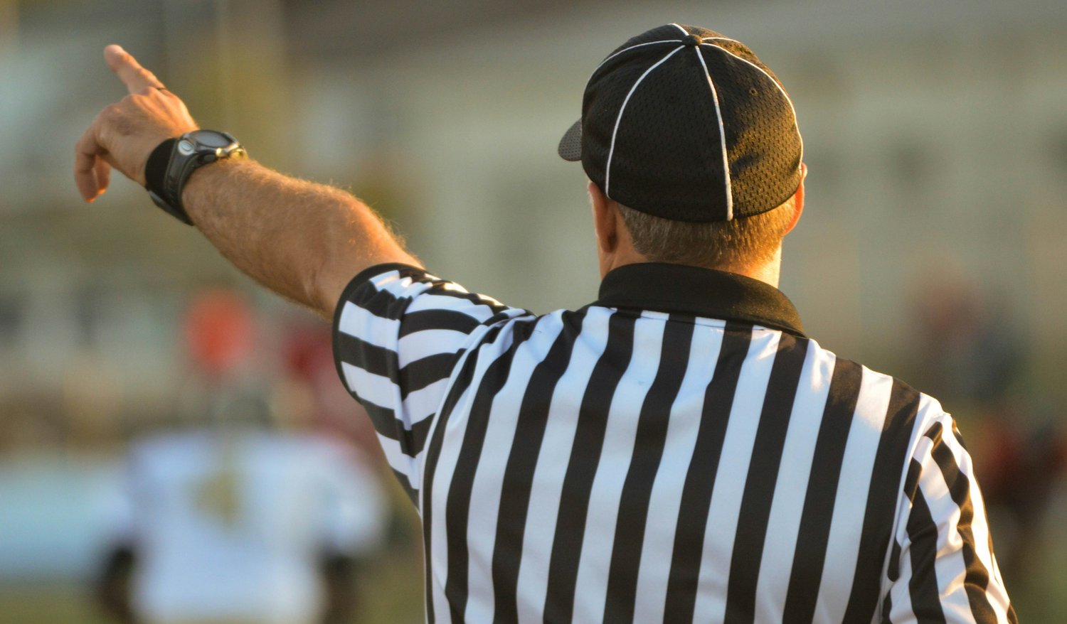 A sports referee pointing their finger