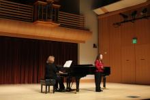 Two people performing on stage during a Vocal Repertory Recital