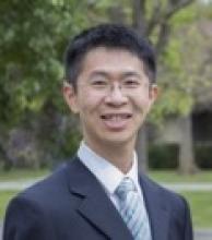A portrait of Dr. Weijian Yang smiling
