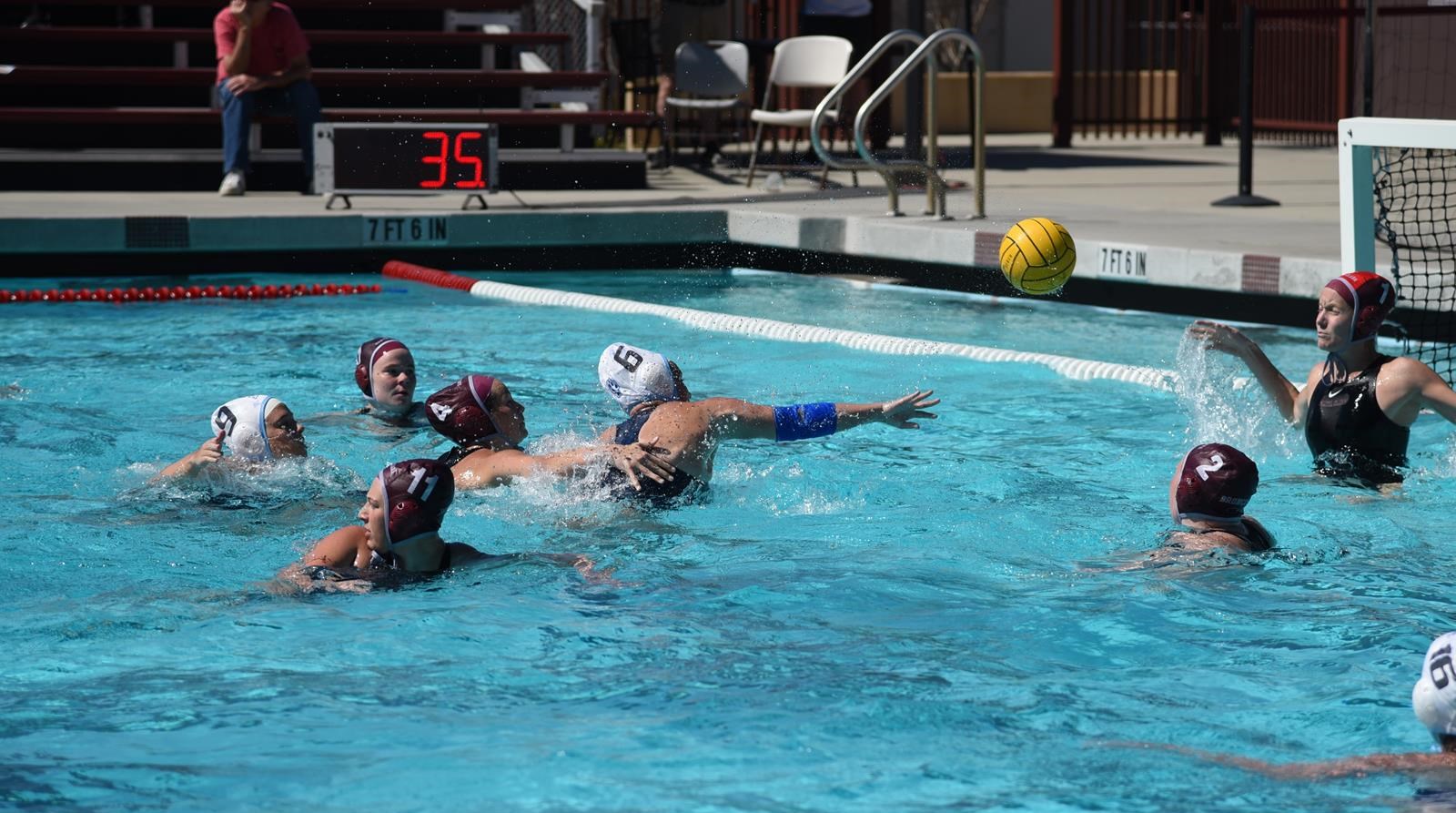 A group of women in a swimming pool playing water polo