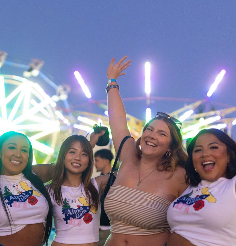 Group of students with hands up in the air cheering