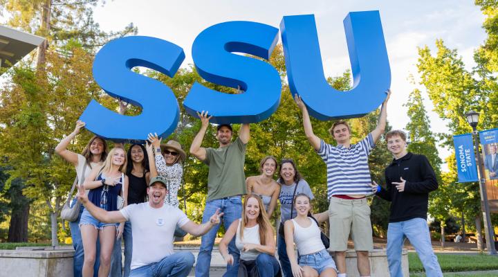 Students holding large SSU letters