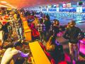 A large group of people bowling in a bowling alley