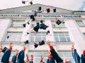 Students throwing their grad caps in the air during graduation 
