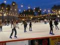 people ice skating at an outdoor ice skating rink