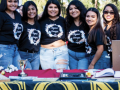 A line of six sorority members smiling while wearing sorority t-shirts