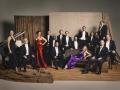 The many members of Pink Martini posed in formal attire