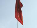 a red flag on a flagpole