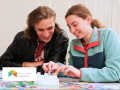 Students smiling while playing a board game