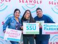 a new Seawolf and their parents holding signs that say they are proud Seawolf parents and that the new student chose SSU