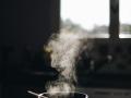 a pot cooking with smoke rising from it