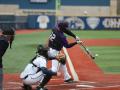 A batter swinging a baseball bat at a baseball game