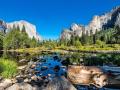 A creek, trees, and rock formations in Yosemite