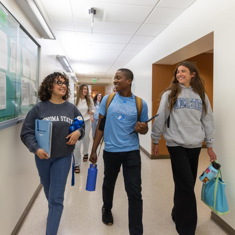Group of students walking down a hallway