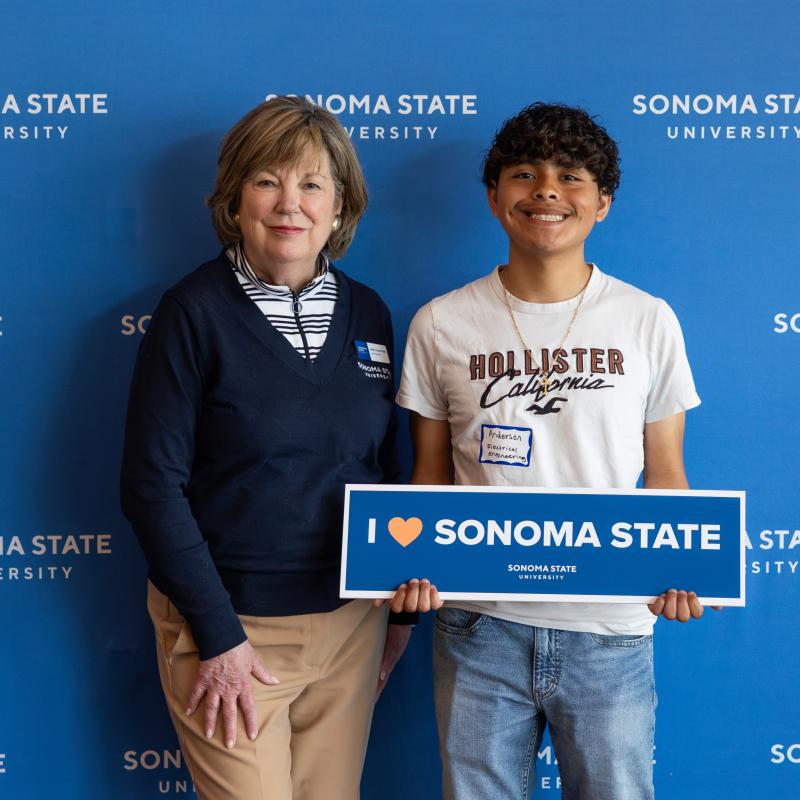 President Emily Cutrer taking a photo with a freshman student